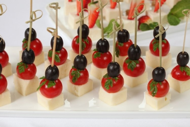 Canapes with olives, cherry tomatoes and goat cheese