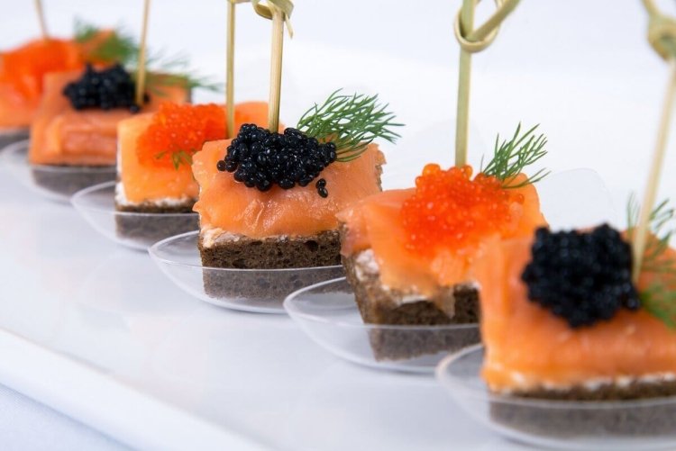 Festive canapes with black caviar and salmon