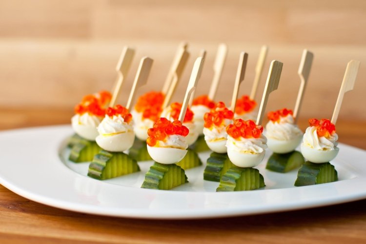Canapes with quail eggs, cucumber and red caviar