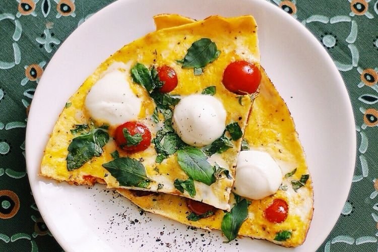Baked omelet with mozzarella, cherry tomatoes and basil