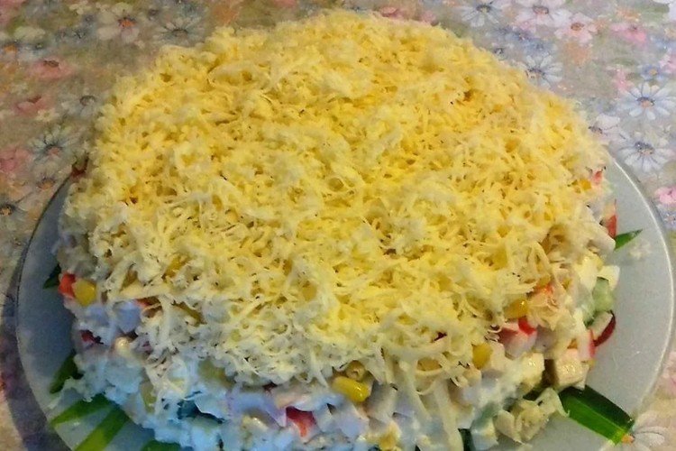 Layered salad with crab meat, corn, cheese and eggs