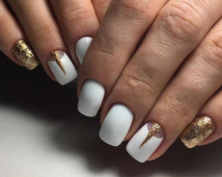 Manicure with golden sparkles on a white background
