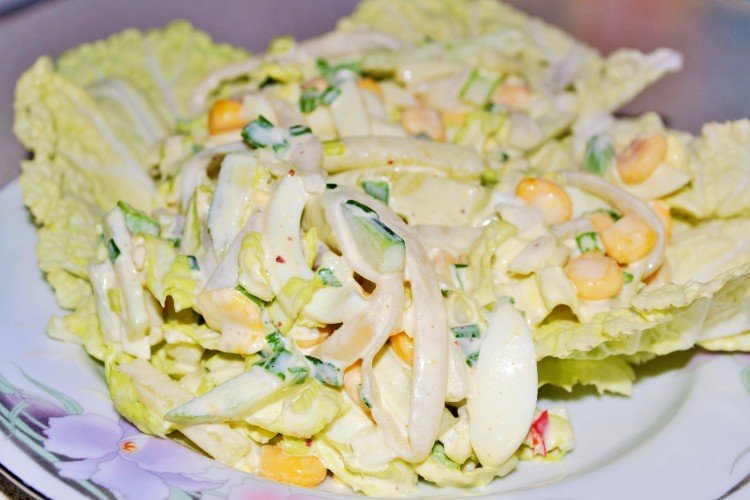 Salad with egg pancakes, squid, cucumbers and corn