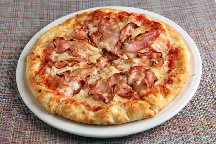 Pizza topping with bacon, cheese and tomatoes